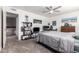 Bright bedroom with a double bed, ceiling fan, and built-in shelving at 1125 E Huber St, Mesa, AZ 85203