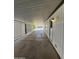 Covered carport with concrete flooring and side yard view at 120 N Val Vista Dr # 38, Mesa, AZ 85213
