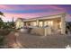 Backyard with covered patio, outdoor kitchen, and putting green at 12920 W Figueroa Dr, Sun City West, AZ 85375