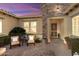 Courtyard entry with stonework, wrought iron gate, and comfortable seating area at 12920 W Figueroa Dr, Sun City West, AZ 85375