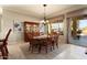 Formal dining room with a wood table, hutch, and access to the patio at 12920 W Figueroa Dr, Sun City West, AZ 85375