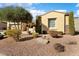 One-story house with desert landscaping and a large tree at 12920 W Figueroa Dr, Sun City West, AZ 85375