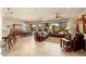 Open living room featuring leather sofas, a large window, and tile floors at 12920 W Figueroa Dr, Sun City West, AZ 85375