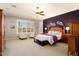 Large main bedroom with dark purple accent wall and ceiling fan at 12920 W Figueroa Dr, Sun City West, AZ 85375