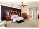 Main bedroom with king-size bed and access to the bathroom at 12920 W Figueroa Dr, Sun City West, AZ 85375