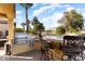 Outdoor kitchen with built-in grill, bar seating, and views of the golf course at 12920 W Figueroa Dr, Sun City West, AZ 85375