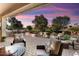 Relaxing patio with seating area, fire pit, and views of a golf course at 12920 W Figueroa Dr, Sun City West, AZ 85375