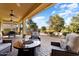 Covered patio with fire pit and seating area at 12920 W Figueroa Dr, Sun City West, AZ 85375