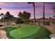 Putting green with seating area and beautiful sunset view at 12920 W Figueroa Dr, Sun City West, AZ 85375