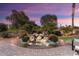 Landscaped backyard with a water feature and beautiful sunset views at 12920 W Figueroa Dr, Sun City West, AZ 85375