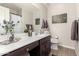 Bathroom with dark vanity, toilet and decorative accents at 1329 N Balboa --, Mesa, AZ 85205