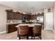 Kitchen with dark wood cabinets, granite countertops and island at 1410 E Palm Beach Dr, Chandler, AZ 85249