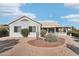 Landscaped backyard with covered patio and desert plants at 15107 W Las Brizas Ln, Sun City West, AZ 85375