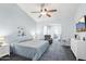 Bright bedroom featuring a ceiling fan and large TV at 15107 W Las Brizas Ln, Sun City West, AZ 85375