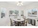 Bright breakfast nook with wood table and four chairs at 15107 W Las Brizas Ln, Sun City West, AZ 85375