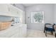 Laundry room with washer, dryer, and upper cabinets at 15107 W Las Brizas Ln, Sun City West, AZ 85375