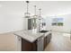 Bright kitchen with center island featuring granite countertops, stainless steel appliances, and pendant lighting at 16065 W Prickly Pear Trl, Surprise, AZ 85387