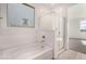 Bathroom features a soaking tub, walk-in shower and a window at 16767 W Cavedale Dr, Surprise, AZ 85387