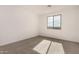 Simple bedroom with neutral carpeting and a large window at 16767 W Cavedale Dr, Surprise, AZ 85387