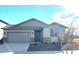 New single-story home with gray exterior, two-car garage, and landscaping at 16767 W Cavedale Dr, Surprise, AZ 85387