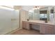 Bathroom features a double vanity, large mirror, and a shower stall at 19810 N 90Th Ln, Peoria, AZ 85382