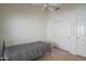 Bright bedroom with ceiling fan and double door closet at 19810 N 90Th Ln, Peoria, AZ 85382