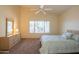 Spacious bedroom with a queen-size bed, dresser, and large window at 19810 N 90Th Ln, Peoria, AZ 85382