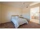 Bedroom with a full-size bed, ensuite bathroom access, and ceiling fan at 19810 N 90Th Ln, Peoria, AZ 85382