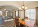 Charming dining room with wooden table and chandelier at 19810 N 90Th Ln, Peoria, AZ 85382