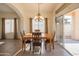 Spacious dining area with wooden table and chandelier at 19810 N 90Th Ln, Peoria, AZ 85382