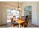 Dining area with table and chairs, sliding door access to backyard, and kitchen views at 19810 N 90Th Ln, Peoria, AZ 85382