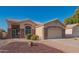 Single-story home with stone accents and a two-car garage at 19810 N 90Th Ln, Peoria, AZ 85382