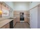 Light and bright kitchen with wood cabinets, white appliances, and a double sink at 19810 N 90Th Ln, Peoria, AZ 85382