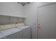 Laundry room with washer, dryer and shelving at 19810 N 90Th Ln, Peoria, AZ 85382