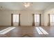 Sunlit living room showcasing tile floors and ample natural light at 19810 N 90Th Ln, Peoria, AZ 85382