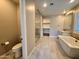 Bathroom featuring a soaking tub, walk-in shower, and toilet at 2074 N 139 Dr, Goodyear, AZ 85395