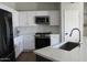 Modern kitchen featuring white cabinets, stainless steel appliances, and a large island at 21249 E Lords Way, Queen Creek, AZ 85142