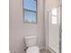 Clean bathroom with toilet, shower, and window at 24040 N 172Nd Ave, Surprise, AZ 85387