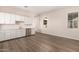 Modern kitchen with white cabinets, a sink, and stainless steel refrigerator at 24040 N 172Nd Ave, Surprise, AZ 85387