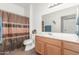 Clean bathroom with shower/tub combo, wood vanity, and updated fixtures at 2663 S Springwood Blvd # 311, Mesa, AZ 85209