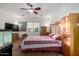 Spacious bedroom with large bed, TV, and built-in cabinets at 3222 S 186Th Ln, Goodyear, AZ 85338