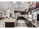 Spacious kitchen featuring granite countertops and dark wood cabinetry at 3222 S 186Th Ln, Goodyear, AZ 85338