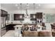 Modern kitchen with island, stainless steel appliances, and dark wood cabinets at 3222 S 186Th Ln, Goodyear, AZ 85338