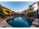 Inviting kidney-shaped pool with water features and a large patio at 3222 S 186Th Ln, Goodyear, AZ 85338
