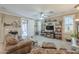 Cozy living room with a fireplace, built-in shelving, and access to a patio at 32974 N Madison Way Dr, San Tan Valley, AZ 85144