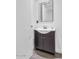 Clean bathroom with dark vanity and framed mirror at 3801 N Goldwater Blvd # 204, Scottsdale, AZ 85251