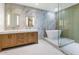 Spa-like bathroom with marble tile and soaking tub at 3801 N Goldwater Blvd # 204, Scottsdale, AZ 85251