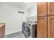 Laundry room with washer, dryer, and extra cabinets at 3801 N Goldwater Blvd # 204, Scottsdale, AZ 85251