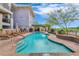 Community pool with surrounding lounge chairs at 3801 N Goldwater Blvd # 204, Scottsdale, AZ 85251