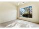 Well-lit bedroom with a large window overlooking trees at 3830 E Carter Dr, Phoenix, AZ 85042